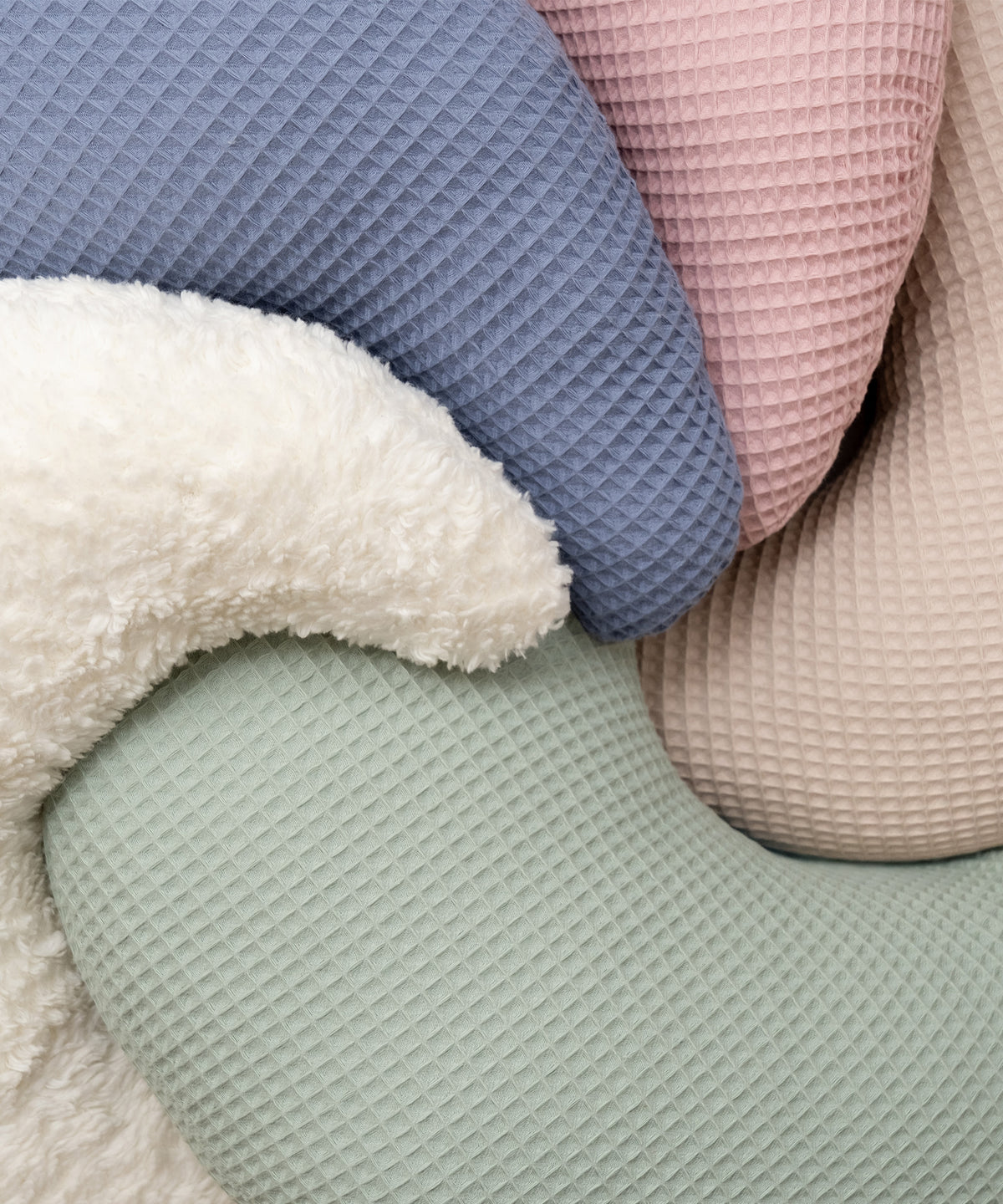 Pflegeleicht im Alltag*Das Kuschelkissen hat keinen störenden Reißverschluss und kann bei 30°C komplett in der Waschmaschine gewaschen werden.| Nahaufnahme der verschiedenen Farben des Kuschelkissens.